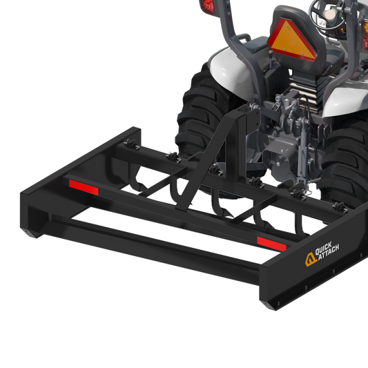 A black tractor grader attachment with red accents, designed for land leveling and landscaping.