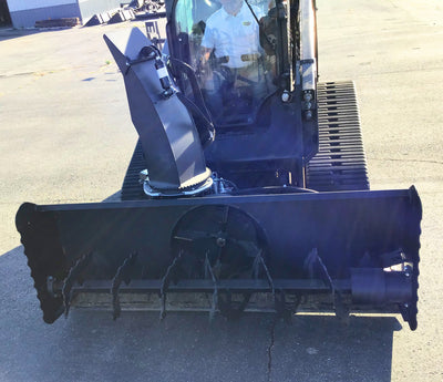 Close-up of a snow plow attachment on a vehicle in an outdoor setting