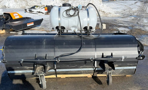 Pick up broom attachment on a snowy field with a tank and pump.