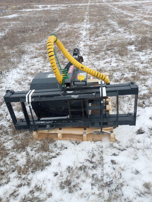 Forklift attachment on a pallet with snow-covered ground in the background