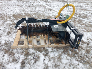Heavy-duty agricultural tool on a wooden pallet with snow-covered ground in the background