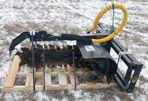 Heavy-duty agricultural tool on a wooden pallet with snow-covered ground in the background