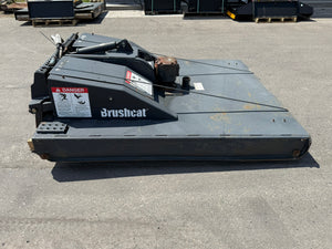 Large agricultural implement with 'Brushcat' branding on a concrete surface.