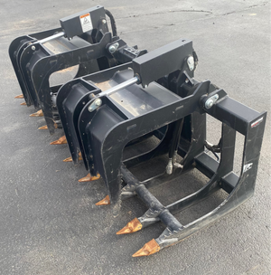 Black grapple attachment on a gray concrete surface