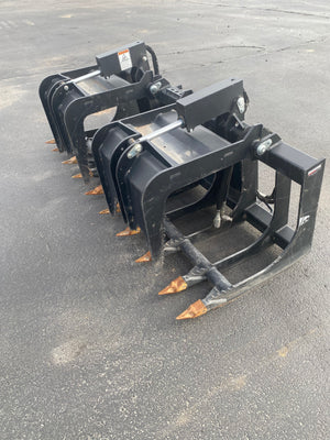 Black grapple attachment on a gray concrete surface