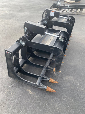 Black grapple attachment on a flatbed truck