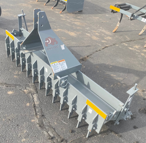 Row of metal grapple attachments on a concrete surface