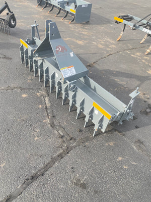 Row of metal grapple attachments on a concrete surface