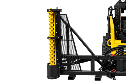 Quick Attach Limb Cutter attachment mounted on a yellow skid steer, with its toothed cutting rotor positioned vertically.