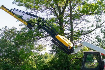 Limb Cutter 6 extended from a boom into the branches of a large tree.