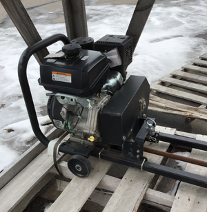 Engine or motor unit on a wooden pallet with snow in the background