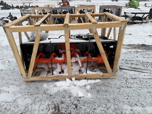 Snowblower in a wooden crate on a snowy ground