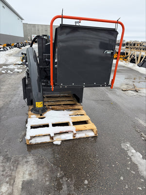 Black machine with orange frame on a wooden pallet outdoors