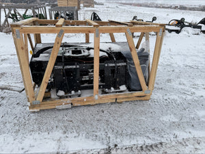 Engine in a wooden crate on a snowy ground
