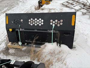 Large black metal attachment on a snowy ground