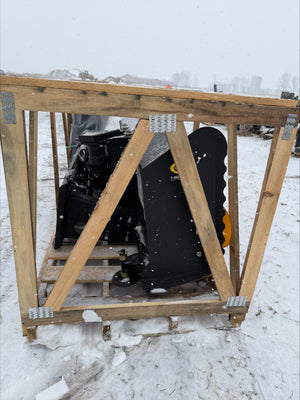 Snowmobile on a wooden pallet in a snowy landscape