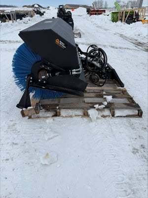 Snow removal equipment on a pallet in a snowy outdoor setting