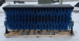 Large blue brush on a wooden pallet in a snowy outdoor setting